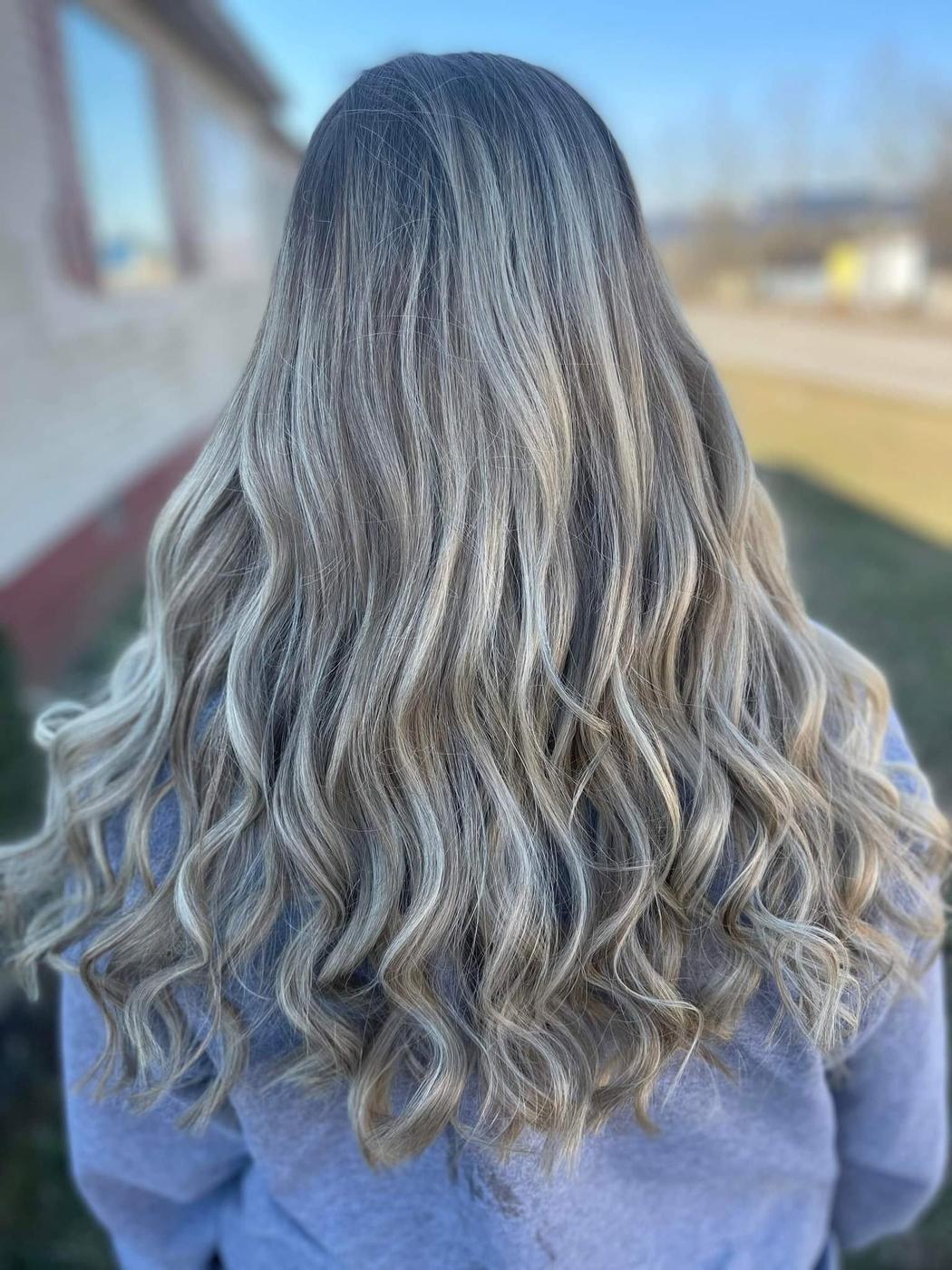 Long cool ash blonde waves, photographed outdoors.